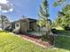 Well-maintained home featuring a covered patio area and lush landscaping, perfect for enjoying the outdoors at 114 Chestnut St, Leesburg, FL 34748