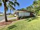 Charming home with a screened porch and well-kept landscaping, providing a relaxing outdoor space at 114 Chestnut St, Leesburg, FL 34748