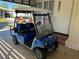 Blue golf cart parked under carport at 114 Chestnut St, Leesburg, FL 34748