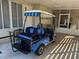 Blue golf cart parked near mobile home entrance at 114 Chestnut St, Leesburg, FL 34748