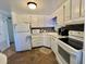 Well-lit kitchen featuring white cabinets, modern appliances, and ample countertop space at 114 Chestnut St, Leesburg, FL 34748