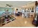 Open-concept living area featuring a sofa, dining table, and hardwood flooring at 114 Chestnut St, Leesburg, FL 34748