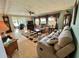 Inviting living room with a plush sofa, recliner, ceiling fan, and decorative rug on wood-look floors at 114 Chestnut St, Leesburg, FL 34748