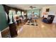 Spacious living room featuring comfortable sofas, hardwood floors, and natural light from the window at 114 Chestnut St, Leesburg, FL 34748
