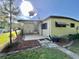 Exterior shot showcases a covered patio extension, perfect for outdoor relaxation and entertaining at 114 Chestnut St, Leesburg, FL 34748