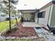 Exterior shot showcases a covered patio extension, perfect for outdoor relaxation and entertaining at 114 Chestnut St, Leesburg, FL 34748