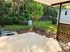 Concrete patio area with wooden lattice and landscaping at 114 Chestnut St, Leesburg, FL 34748