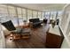 Relaxing sun room with a futon, rocking chair, and many windows providing natural light at 114 Chestnut St, Leesburg, FL 34748
