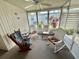 Relaxing sunroom featuring wicker rocking chairs, a ceiling fan, and a view at 114 Chestnut St, Leesburg, FL 34748