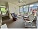 Relaxing sunroom with a ceiling fan, carpet, and wicker furniture at 114 Chestnut St, Leesburg, FL 34748