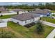 Aerial view of a single-Gathering home with a landscaped yard and white fence at 12018 Indian Grass Way, Leesburg, FL 34788