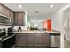 View of kitchen with granite countertops and stainless steel appliances at 12018 Indian Grass Way, Leesburg, FL 34788