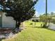 Landscaped backyard with mature trees and patio at 123 Pyracantha Ln, Leesburg, FL 34748