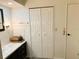 Bathroom with dark brown vanity, a large mirror and double door linen closet at 123 Pyracantha Ln, Leesburg, FL 34748