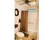 Bathroom with shower/tub combo, toilet, and wicker decor at 123 Pyracantha Ln, Leesburg, FL 34748