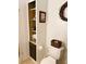 Bathroom with a built-in storage unit and toilet at 123 Pyracantha Ln, Leesburg, FL 34748