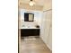 Bathroom features a vanity with dark brown cabinets, a large mirror and linen closet at 123 Pyracantha Ln, Leesburg, FL 34748