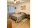 Main bedroom with king-size bed and ceiling fan at 123 Pyracantha Ln, Leesburg, FL 34748