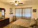 Main bedroom with king-size bed and ceiling fan at 123 Pyracantha Ln, Leesburg, FL 34748