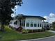 Single-wide manufactured home with mature landscaping at 123 Pyracantha Ln, Leesburg, FL 34748