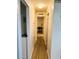 Long hallway with light wood floors at 123 Pyracantha Ln, Leesburg, FL 34748