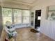 Relaxing sunroom with wicker chairs and tiled flooring at 123 Pyracantha Ln, Leesburg, FL 34748