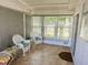 Sunroom with tiled floor and wicker chairs at 123 Pyracantha Ln, Leesburg, FL 34748