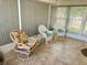 Bright sunroom with wicker chairs and tiled floor, offering a relaxing outdoor feel at 123 Pyracantha Ln, Leesburg, FL 34748