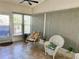 Relaxing sunroom with tiled floors, comfortable seating, and multiple windows at 123 Pyracantha Ln, Leesburg, FL 34748