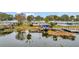Waterfront property with private dock, lush surroundings and serene lake views, offering a peaceful retreat at 13 Sunrise Trl, Fruitland Park, FL 34731