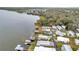 Aerial view of waterfront community with lake access and numerous homes at 13 Sunrise Trl, Fruitland Park, FL 34731