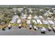 Aerial view of waterfront homes with boat docks on a calm lake in a lush, green community at 13 Sunrise Trl, Fruitland Park, FL 34731