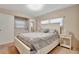 Bedroom showcasing neutral carpeting, a large bed, and natural light from windows at 13 Sunrise Trl, Fruitland Park, FL 34731