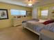 Bedroom featuring neutral carpeting, a ceiling fan, and a comfortable king-sized bed at 13 Sunrise Trl, Fruitland Park, FL 34731