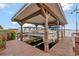 Covered boat dock featuring a boat lift, providing convenient access to the water at 13 Sunrise Trl, Fruitland Park, FL 34731