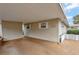 Covered carport featuring a concrete floor and white trimmed windows, offering convenient parking at 13 Sunrise Trl, Fruitland Park, FL 34731
