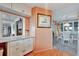 Dining area with wood floors, cabinets, breakfast bar, and connection to living area at 13 Sunrise Trl, Fruitland Park, FL 34731