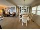 Inviting dining area featuring a glass front cabinet, a chandelier, and seating for four at 13 Sunrise Trl, Fruitland Park, FL 34731