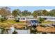 Charming waterfront home with well-manicured lawn and a private boat dock for enjoying lake activities at 13 Sunrise Trl, Fruitland Park, FL 34731