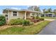 Well-maintained home with a covered carport, tidy landscaping and a brick-lined garden bed at 13 Sunrise Trl, Fruitland Park, FL 34731