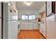 Bright kitchen with white cabinets, wood flooring and stainless steel appliances at 13 Sunrise Trl, Fruitland Park, FL 34731