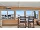 Serene lake view visible through windows, complemented by bar stools and a cozy atmosphere at 13 Sunrise Trl, Fruitland Park, FL 34731