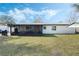 View of the home's exterior, highlighting the backyard and patio area at 1301 Sand Pine Ave, Ocoee, FL 34761