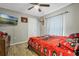 Bright bedroom with ceiling fan, large window, and wood-look floors at 1301 Sand Pine Ave, Ocoee, FL 34761