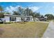 Front view of a renovated home with a well-maintained lawn at 1301 Sand Pine Ave, Ocoee, FL 34761