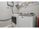 Convenient laundry room with washer and dryer, and additional shelving at 1301 Sand Pine Ave, Ocoee, FL 34761