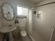 Simple bathroom with white tile, shower, and pedestal sink at 13369 Cr 719, Webster, FL 33597