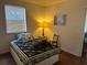 Cozy bedroom with a bed, lamp, and wood floors at 13369 Cr 719, Webster, FL 33597