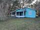 Quaint light blue house with a porch swing at 13369 Cr 719, Webster, FL 33597