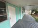 Long covered porch with gray decking at 13369 Cr 719, Webster, FL 33597